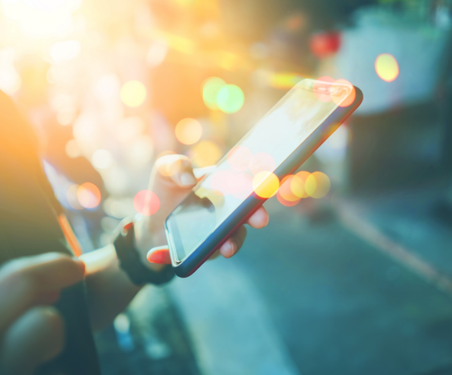 A person holding their phone in the air.