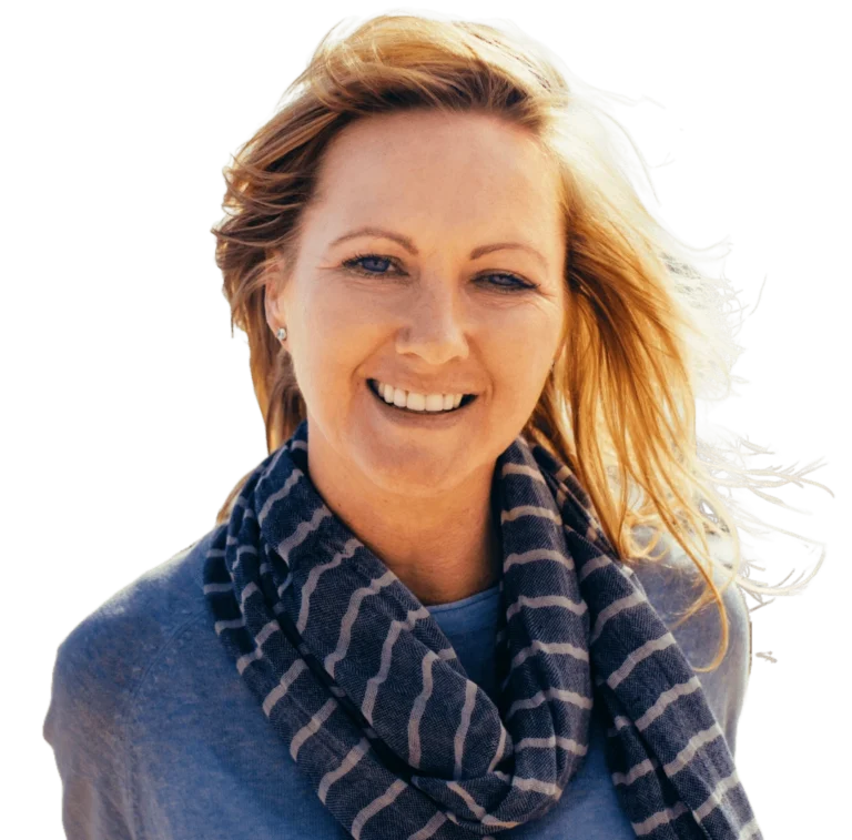 A woman with blonde hair wearing a blue sweater and scarf.